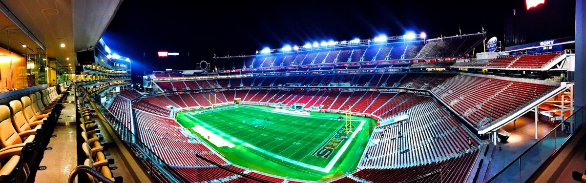 A panoramic night view of Levi's Stadium in Santa Clara, highlighting vibrant lights.