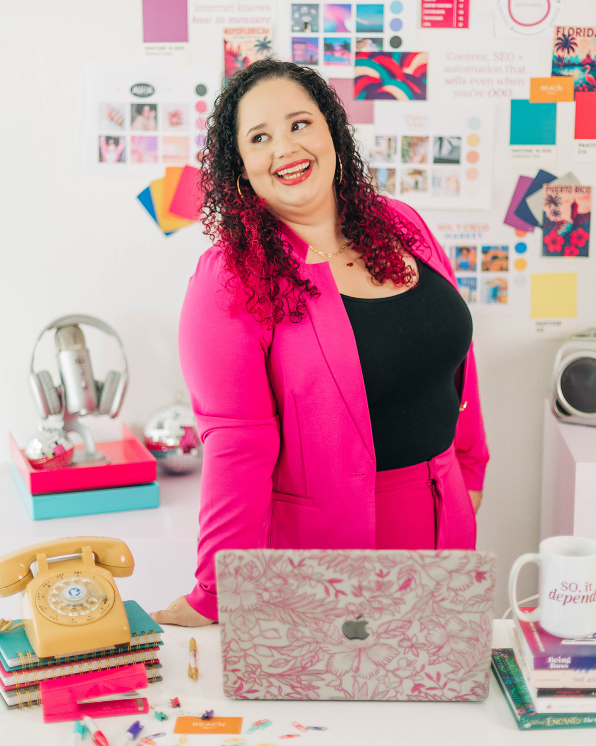Kristine Gonzalez, AI automation consultant, at her strategy workspace with brand materials and color palettes